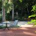 Hardtwald, Bad Homburg: outdoor patio with table and chairs in a wooded garden setting