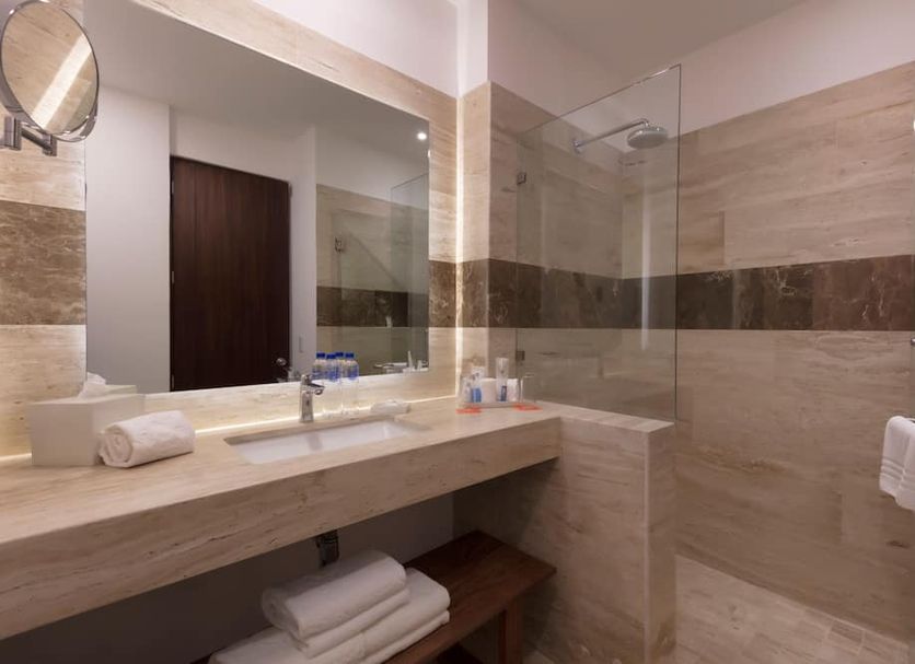 Krystal Puerto Vallarta bathroom with marble vanity, walk-in shower and folded towels