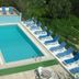 Gultepe Apartments in Kusadasi with outdoor pool, sun loungers, and terrace seating