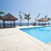 Tanjung Alam Hotel in Buleleng with a seaside pool, gazebos, palm trees, and ocean view