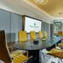 The Chancery Hotel in Dublin meeting room with long conference table and yellow chairs by glass walls