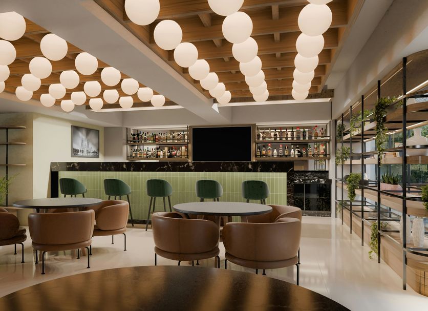 Hilton Garden Inn Mexico City Polanco lobby lounge with round tables, bar, and hanging globe lights