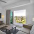 The Avalon Club in Clearwater Beach room with balcony view, TV, sofa and coffee table