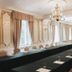 Dwór Sieraków in Sieraków: elegant meeting room with long conference table, chandeliers, and tall windows