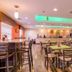 La Quinta Inn & Suites by Wyndham Grand Forks lobby breakfast area with tables, chairs and a counter