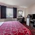 Super 8 by Wyndham Kirkland Lake guest room with bed, desk, TV, and window blinds