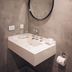 Suma Recoleta Hotel in Buenos Aires bathroom vanity with round mirror and wall-mounted sink