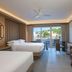 JW Marriott St. Maarten Beach Resort & Spa room with three beds, balcony view, and workspace