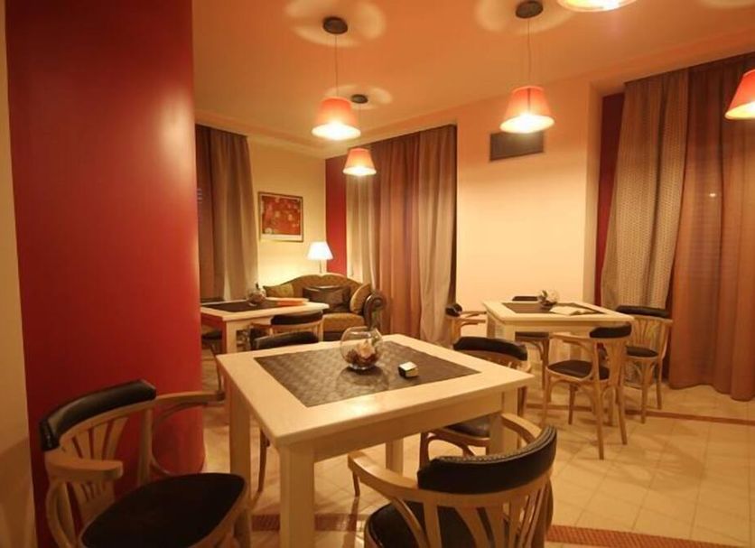 Palace Hotel Una Nuova Strada in Nocera Terinese lounge with tables, chairs and warm pendant lighting