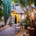 Marulivo Hotel in Pisciotta courtyard with plants, seating, and arched exterior walls
