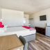 OYO Hotel Waco University Area/I-35 room with two beds, wall-mounted TV and mini fridge in Waco