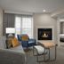 Homewood Suites by Hilton Alexandria/Pentagon South living room with fireplace, TV and seating area in Alexandria