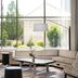 The Westin Reston Heights lobby with large windows, sectional seating, and landscaped courtyard views in Reston