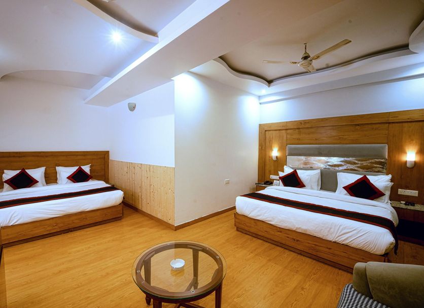 Grand Legacy Beacon, Dehradun guest room with two double beds and a seating area