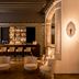 Sant Francesc Hotel Singular in Palma de Mallorca lounge with bar, chairs and warm ambient lighting