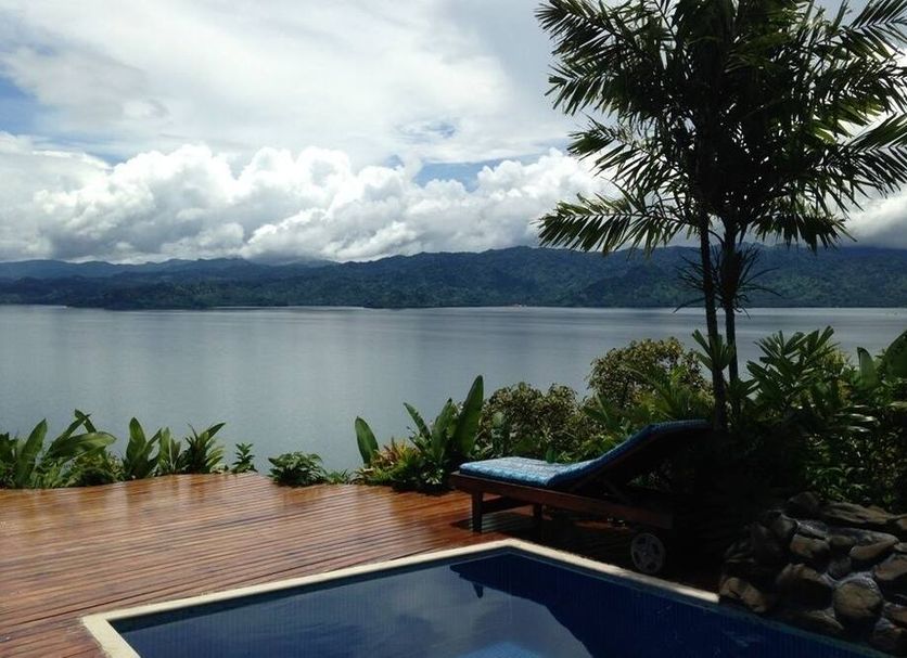 Naveria Heights Lodge in Savusavu with a pool and deck overlooking the bay and mountains