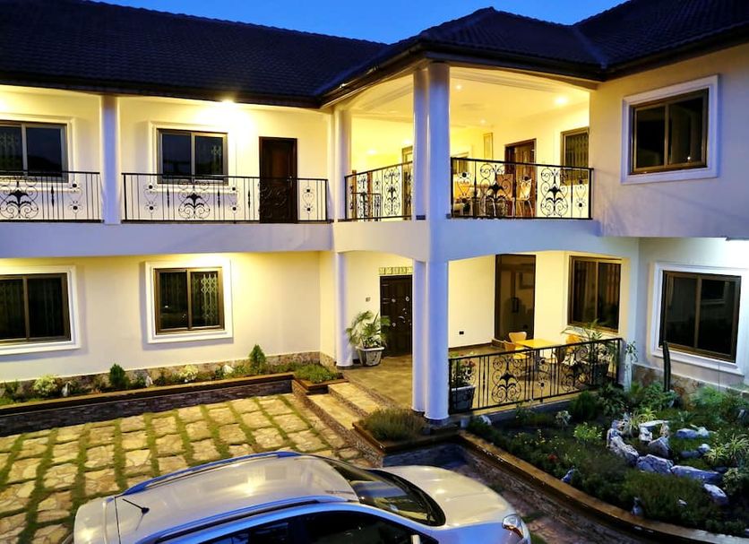 Eden Vale Hotel in Madina, lit courtyard with balconies and parked car outside the hotel