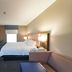 Hampton Inn and Suites Jamestown guest room with king bed, TV, desk and chair
