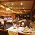 Akiu Resort Hotel Crescent in Sendai dining room with set tables and large windows at night