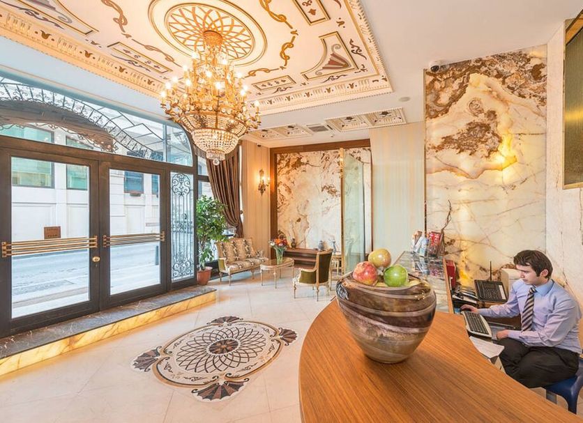 Hotel The Pera Hill lobby in Istanbul with chandelier, marble decor, and seating area