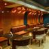Fabhotel Prime Chennai Deluxe lounge seating with booths, tables and warm wood-accent lighting in Chennai