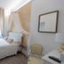 Soggiorno La Coccinella in Florence, compact guest room with canopy bed and sheer curtains