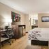 Red Roof Inn Baltimore South - Glen Burnie guest room with king bed, desk, mini-fridge and TV