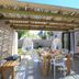 Scallop Guest Lodge Plettenberg Bay outdoor dining terrace with pergola and open glass doors