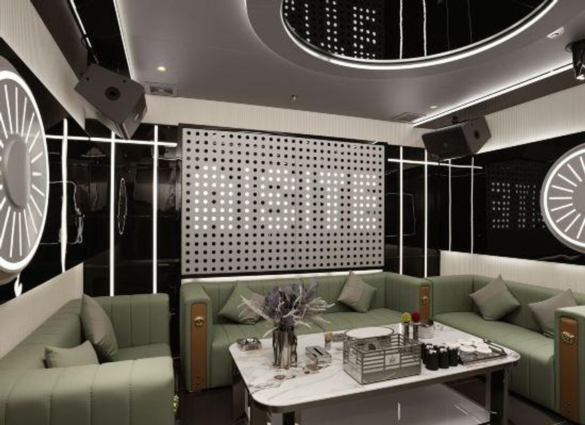 Master Hotel Huizhou lounge with green sofas, marble table, and modern wall lights