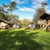 Yha Truleigh Hill in Shoreham-by-Sea with glamping pods, cabins and picnic tables on a grassy lawn