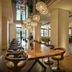 The Nikolai Hamburg lounge and bar with long dining table and pendant lights in Hamburg