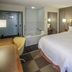 Hampton Inn South Haven guest room with king bed, sofa, desk, and soaking tub