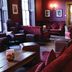 Hotel Du Vin & Bistro Tunbridge Wells lounge in Royal Tunbridge Wells with burgundy armchairs and wall sconces
