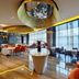 Wuxi Idea Garden Hotel in Wuxi dining area with floor-to-ceiling windows and orange chairs