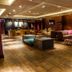 DoubleTree by Hilton Amsterdam – NDSM Wharf lounge with sofas, armchairs and wood flooring