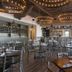 SpringHill Suites by Marriott Orange Beach at The Wharf dining area with tables, chairs, and pendant lights