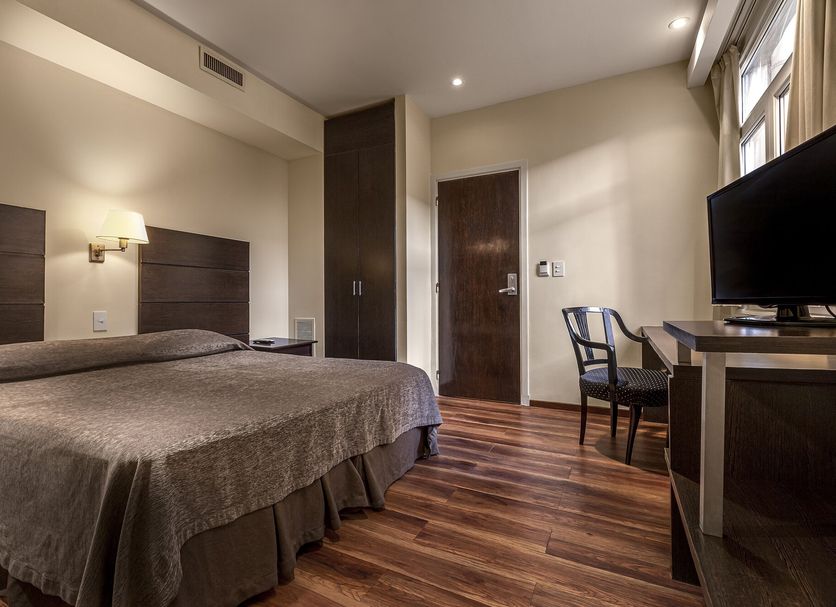 Gran Hotel Argentino Buenos Aires guest room with double bed, desk, chair, and TV