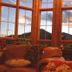 Wildberry Lodge in Leicester: cozy lounge with sofa, lamp and mountain view through large windows