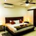 Casa Ticul Hotel By Bfh Playa del Carmen guest room with king bed, ceiling fan, air conditioning, and bedside lamps