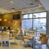 Hotel La Boroña in Gijón lobby bar with tables, chairs, counter, and large windows