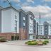Candlewood Suites Houston (The Woodlands) By IHG exterior with entrance drive, flagpole, and trees in The Woodlands