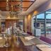 Royalton CHIC Punta Cana dining room with long table, red chairs, and decorative chandeliers