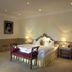 Schloss Diedersdorf hotel room in Diedersdorf with king bed and sitting bench