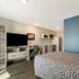 WoodSpring Suites Morrisville - Raleigh Durham Airport room with bed, TV, desk and kitchenette
