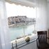 Panorama Junior Suites in Kavála room with bay window, TV, chair and harbor view