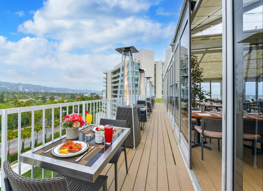 The Beverly Hilton in Beverly Hills terrace dining with mountain view and outdoor tables