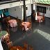 Grand Crown Hotel Anuradhapura dining area with round tables and chairs under a skylit ceiling