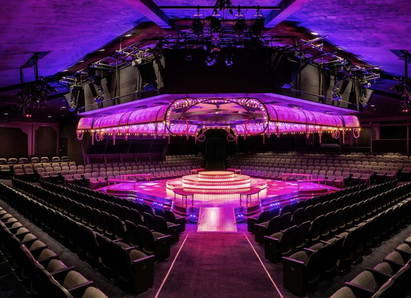 Lincolnshire Marriott Resort event theater with purple-lit stage and rows of seating