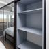 Micro Boutique Living Fredericton room with mirrored wardrobe, twin beds, and balcony view of trees
