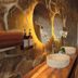 Contemplacion Resort & Spa in Ensenada spa room with stone walls, mirrors and a wooden bench